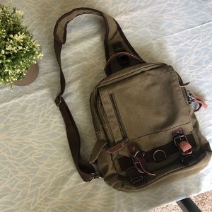 Army green canvas sling bag with leather trim
